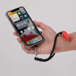 A smartphone held in a hand, featuring a clear case and a red strap with a clip attachment.