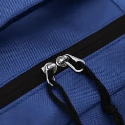 A blue bag with a zippered compartment and metal zipper pulls, featuring black accents.