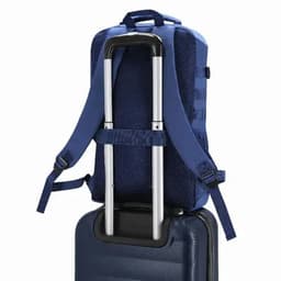 A blue backpack with straps is positioned on top of a suitcase, featuring a handle for easy transport.