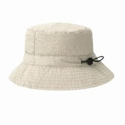 A light beige bucket hat with a textured finish and an adjustable tie on the side. 