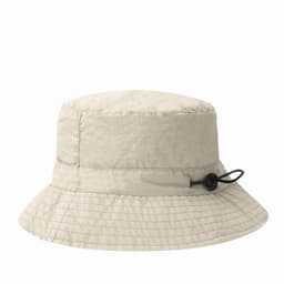 A bucket hat in light beige with a textured fabric and an adjustable drawstring. It features a wide brim.