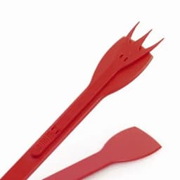 A set of red plastic utensils including a fork-like tool and a spatula. The utensils have a sleek design.