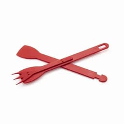 A set of red cooking utensils, including a spatula, fork, and scraper arranged in a cross formation.