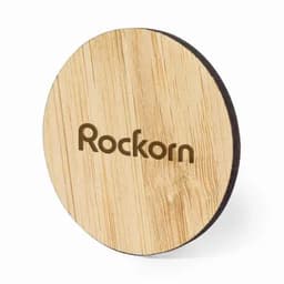 A wooden coaster with a round shape, featuring a light wood finish and a logo.