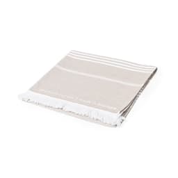 A beige cotton towel with white stripes and fringed edges, featuring a subtle logo.