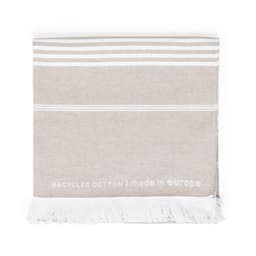 A beige towel with white stripes and fringes, made from recycled cotton, featuring a branding logo.