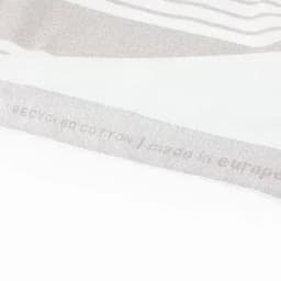 A light grey, textured fabric with a subtle pattern and a logo on one side.