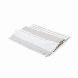 A folded towel in neutral tones, featuring alternating stripes of white and light grey. The towel has a textured finish.