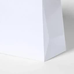 A white paper bag with a clean design and seamless side, featuring a smooth surface.