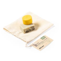 A solid shampoo soap set featuring a yellow bar and a cream bar with black speckles, presented in a fabric pouch.