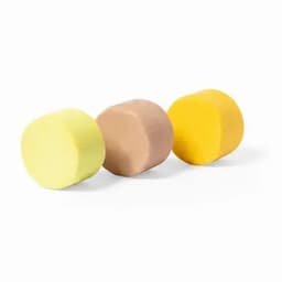 Three cylindrical blocks of play dough in yellow, brown, and light beige, each with a smooth surface.