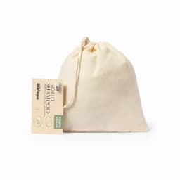 A solid shampoo packaged in a natural fabric bag, featuring a tag and showcasing a cream colour.