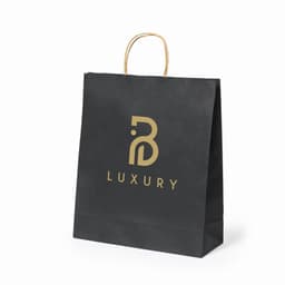 A black paper shopping bag with a gold logo and handles. The bag features the word "LUXURY" prominently.