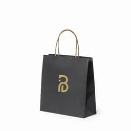A black paper bag with a gold logo and two handle straps.