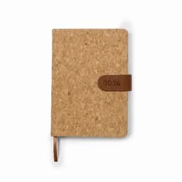 A cork notebook with a brown leather strap, featuring the year 2026 embossed on the strap.