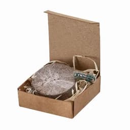 A gift box containing a circular product and a capsule, with brown packaging and straw filling.
