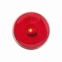A red circular light with a textured surface and a central bulb, featuring a logo.