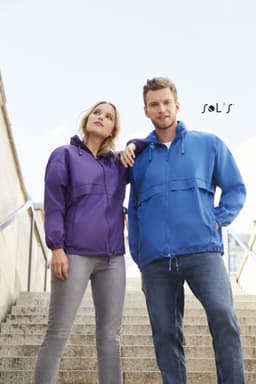 A purple and a blue unisex raincoat made of 100% waterproof nylon, featuring a hood and front pockets.