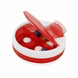 A pill organiser with a red and white design, featuring compartments for multiple tablets. The lid is partially open.