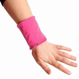 A pink wristband is worn on a wrist, featuring a zip closure and a soft fabric design.
