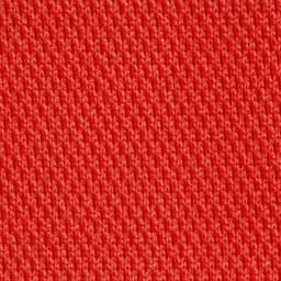 A close-up of a textured fabric in a bright red colour, showcasing its knit pattern.