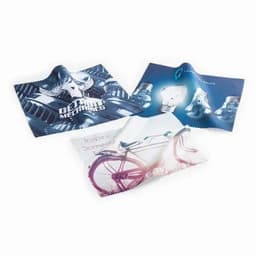 Three cleaning cloths in various designs featuring images of a bike, mechanical elements, and abstract art, with a logo present.