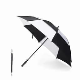 A black and white striped umbrella stands open, next to a closed black umbrella. Both have a sleek design.
