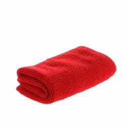 A red, folded towel made from a soft, textured fabric. The towel is compact and neatly arranged.