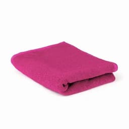 A folded towel in a vibrant fuchsia colour, showcasing a soft texture.