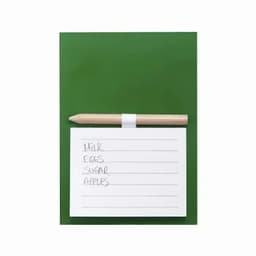 A green notepad with a list of grocery items and a wooden pencil resting on top.