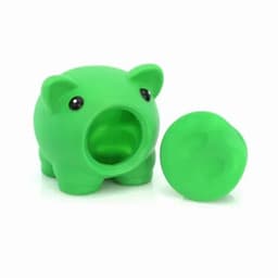 A green pig-shaped coin bank with a removable coin slot cover. Features round black eyes.