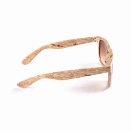 A pair of sunglasses with light brown frames featuring a textured design and gradient lenses. Includes a logo.