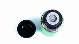 A drink bottle in vibrant green with a black cap, featuring a logo on the rim.