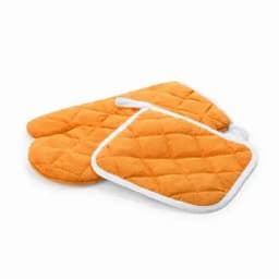 A set of orange quilted oven mitts and a pot holder, featuring a soft texture and white trim.