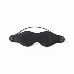 A sleep mask in black with a contoured design and adjustable straps for comfort.