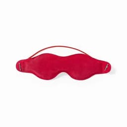 A sleep mask in vibrant red with a curved design and a strap for securing it in place.