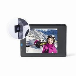 A digital photo frame displaying a snowy mountain scene with a woman in ski attire. The frame has a logo.