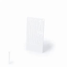 A white product featuring various grooves and a small tool on the side, possibly for shaping or crafting.