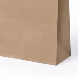 A brown paper bag with a flat base, featuring a minimalist design and no visible branding.
