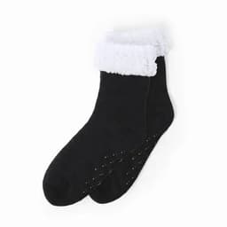 A pair of black socks with a white fluffy cuff and non-slip dots on the soles.