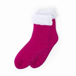 Fuzzy pink socks with a white cuff and non-slip dots on the sole.