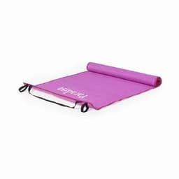 A yoga mat in pink, rolled out flat with carrying straps on the sides and a logo visible on the surface.