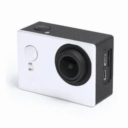 A camera with a black textured body and silver front, featuring a lens and multiple ports on the side.