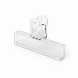 A clear plastic clip with a metal spring mechanism, designed for holding papers or documents securely.