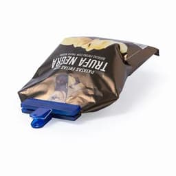 A snack bag clip in blue, securing a partially open packet of chips with a dark brown design.