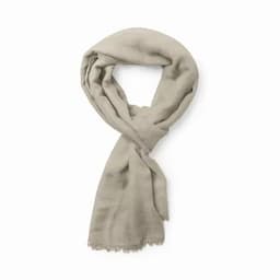 A light beige scarf with a soft texture and frayed edges, elegantly draped in a loop.
