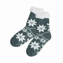 A pair of dark green socks with white snowflake patterns and a fluffy white cuff. The socks have a knitted texture.