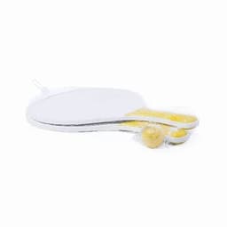 A paddle with a white surface and yellow handle, featuring a small yellow ball attached. It has a logo on it.