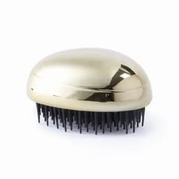 A hairbrush with a shiny gold-shaped top and black bristles, featuring a branding logo.