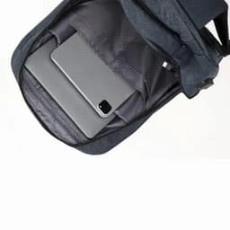 A grey wheeled trolley backpack with a padded compartment displaying a laptop and a phone inside.